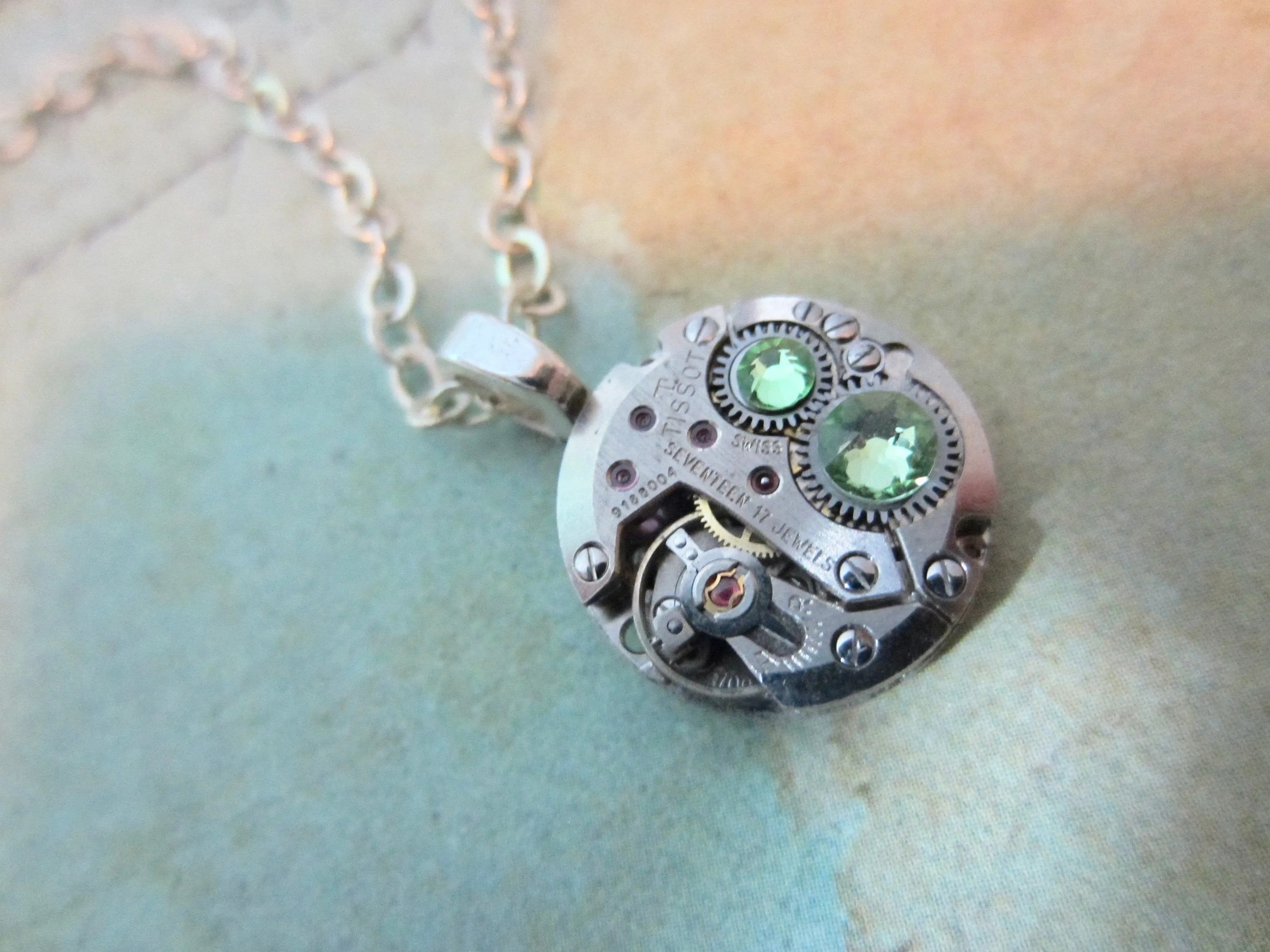 Watch part necklace - Bullet Proof - Steampunk Necklace - Repurposed Art Peridot Swarovski crystals.
