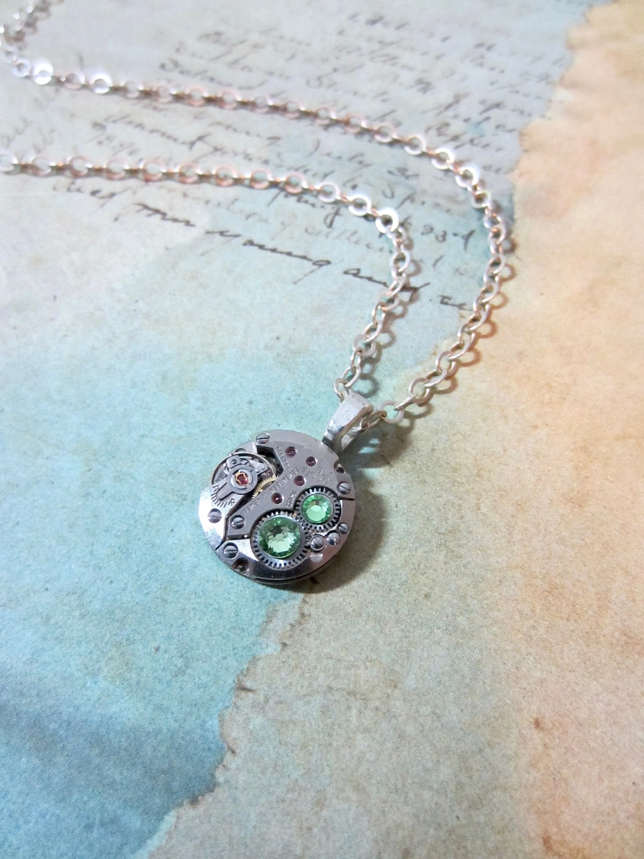 Watch part necklace - Bullet Proof - Steampunk Necklace - Repurposed Art Peridot Swarovski crystals.